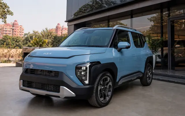 Kia Syros offers Bharatpur hero image showing the Syros outside a Rajasthan dealership for buyers checking live quote timing, variant fit, and booking readiness.