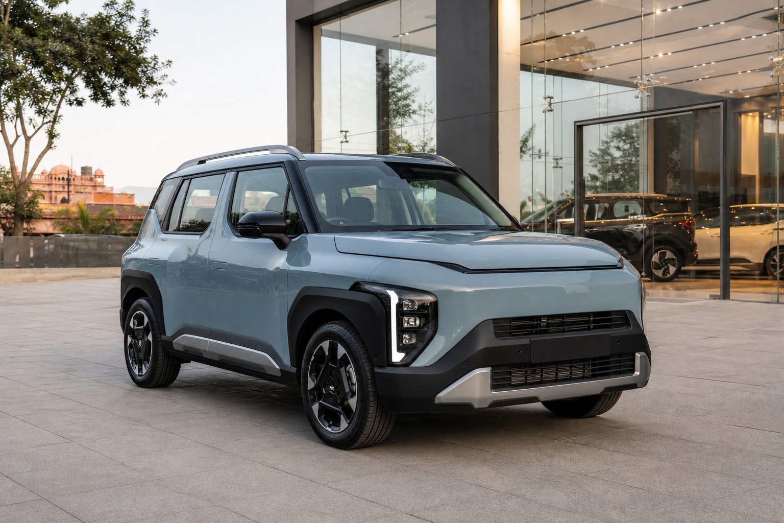 Kia Syros buying decision Jaipur hero image showing the SUV outside a Jaipur dealership for buyers comparing test drive and quote readiness.