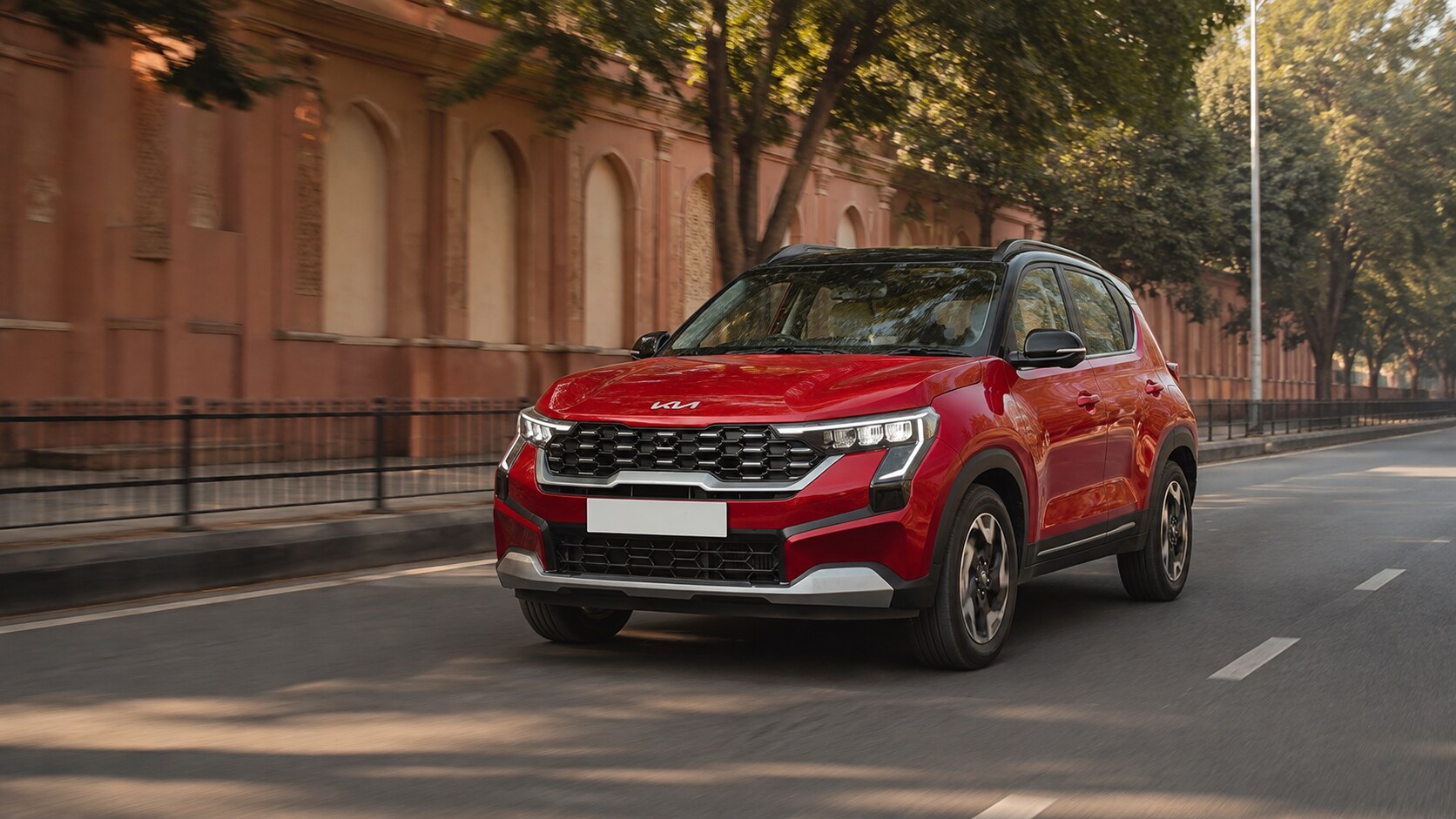 Kia Sonet manual vs automatic Jaipur guide with a red Sonet on a Jaipur urban road
